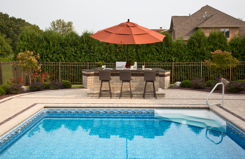 Outdoor bar area with seating beside a pool