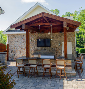 Outdoor patio grilling area with eating area and seating
