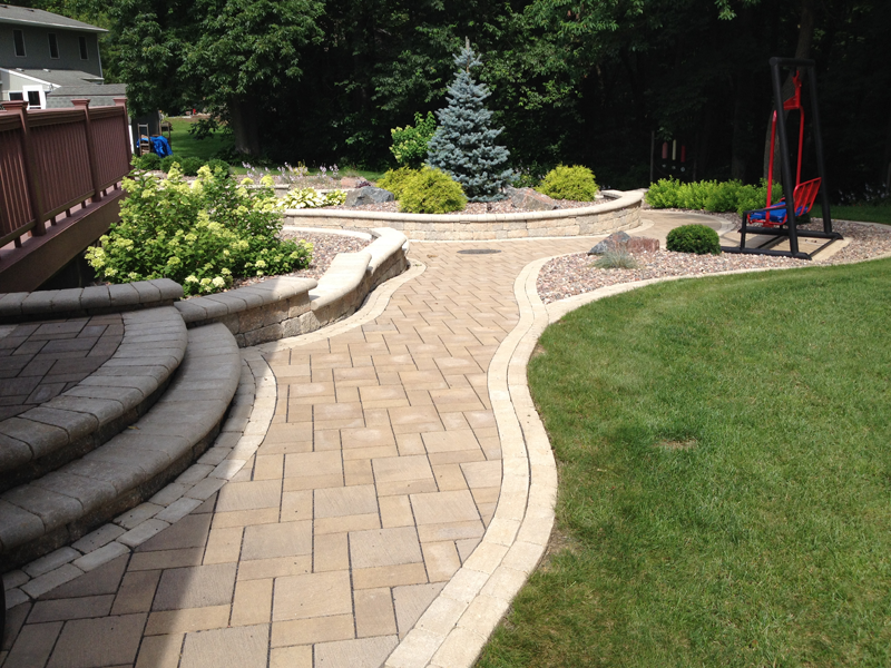 Pathway with small retaining wall and a porch swing